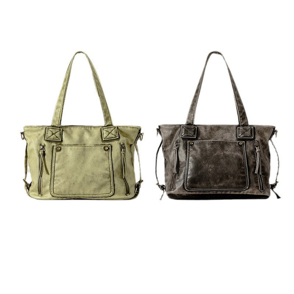 Distressed leather-look convertible tote bag with dual top handles, front zip and patch pockets, and adjustable shoulder