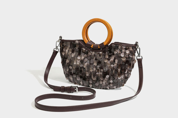 Small sequin half-moon handbag with circular wood-look ring handles and detachable leather-look shoulder strap, detail view