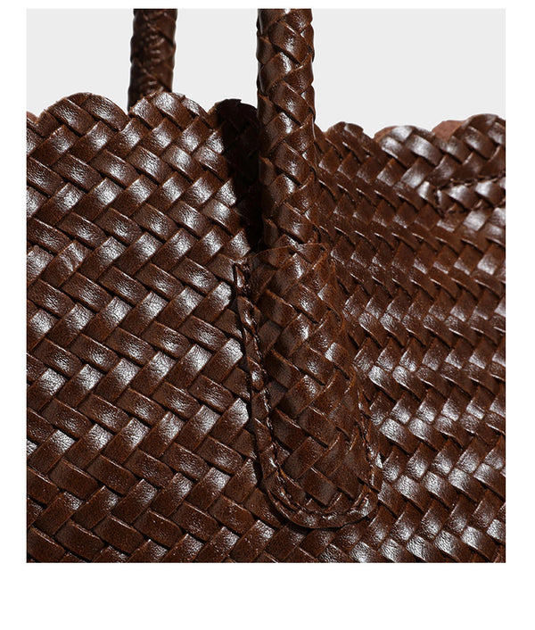 Large open-top woven leather-look tote bag in dark brown with scalloped edge, braided double shoulder straps, and decorative