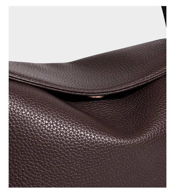 Structured pebbled leather-look shoulder bag with flap top, gold-tone emblem hardware, dual top handles, and detachable