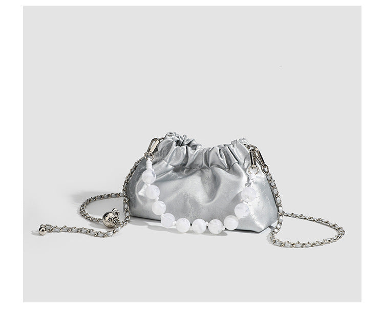 Small ruched drawstring pouch bag with pearl-bead handle and silver-tone chain strap, detail view 9