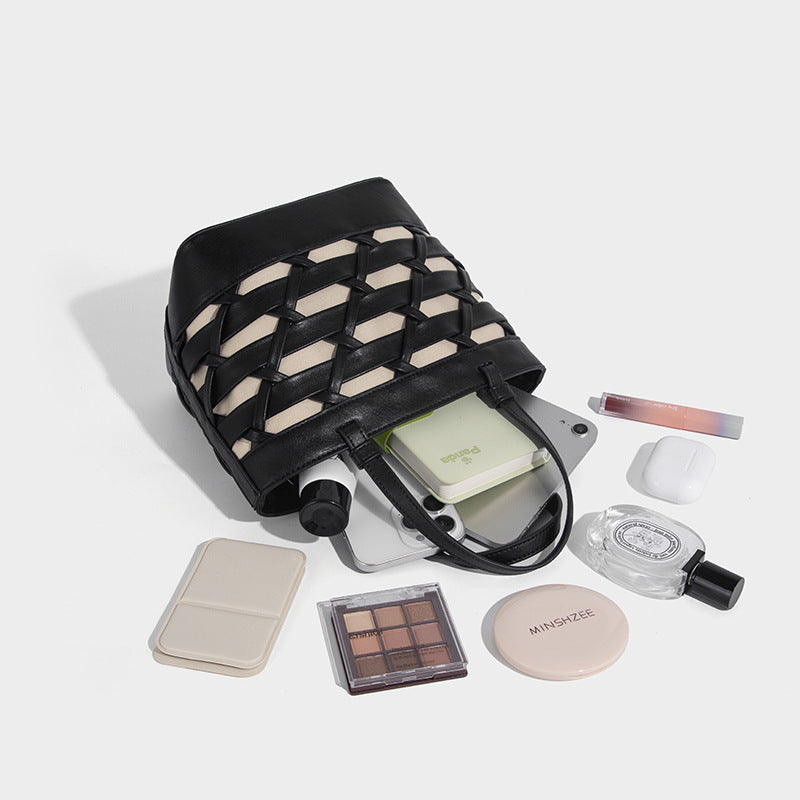 Structured woven lattice tote bag with cream lining, dual top handles, detachable crossbody strap, and silver-tone hardware