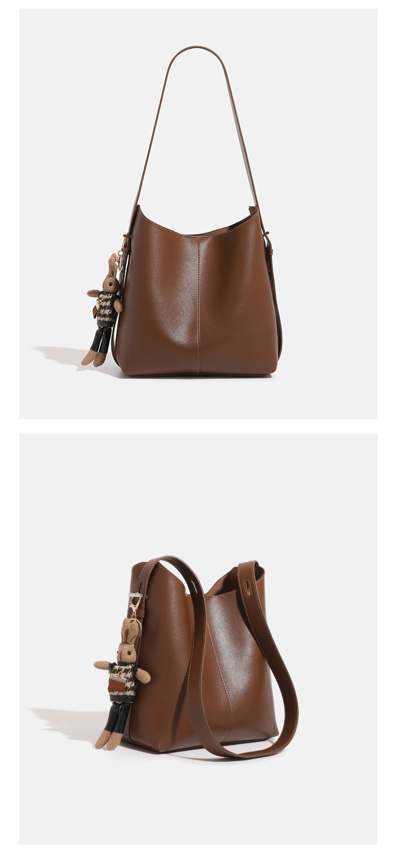Smooth leather-look bucket bag with long flat shoulder strap, open top, gold-tone hardware, and decorative rabbit charm