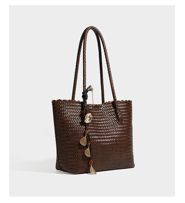 Large open-top woven leather-look tote bag in dark brown with scalloped edge, braided double shoulder straps, and decorative
