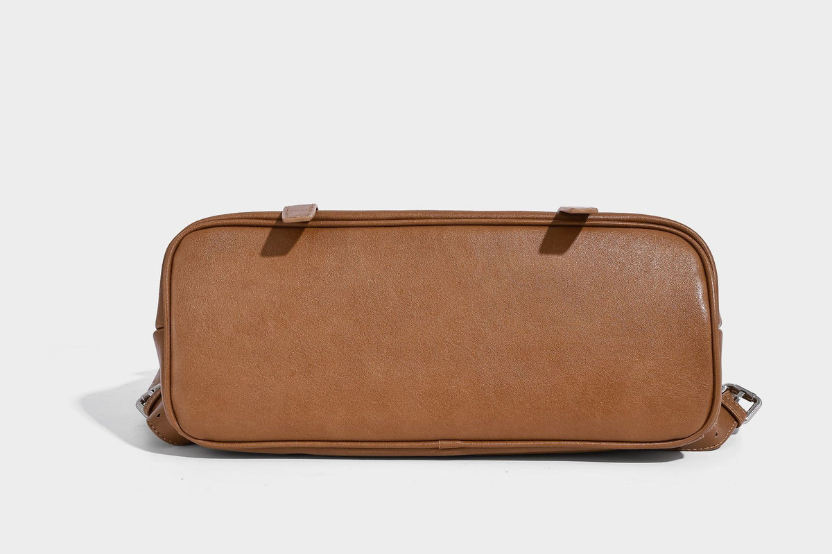 Structured tan leather-look flap backpack handbag with top handle, silver buckle hardware, and fold-over front closure
