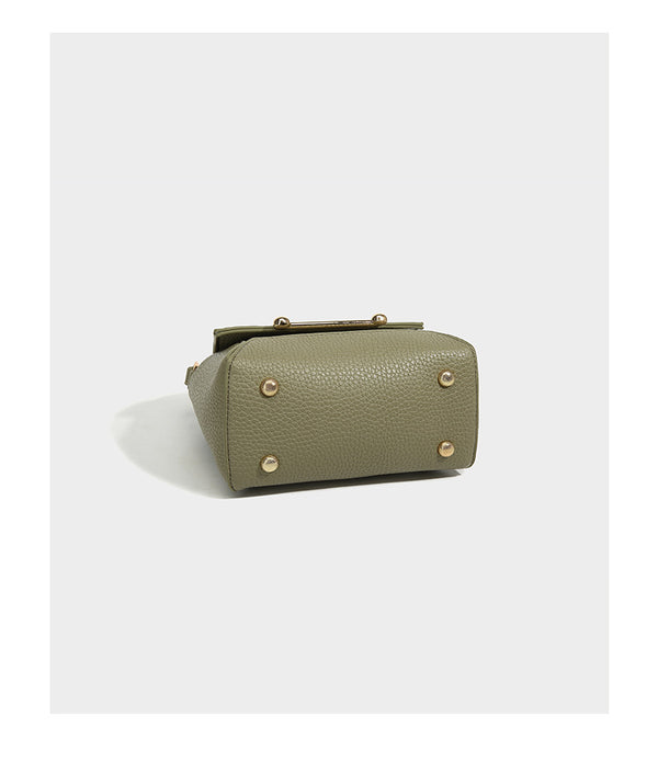 Small structured pebbled flap mini satchel with gold-tone bar hardware, short top handle, and detachable crossbody strap