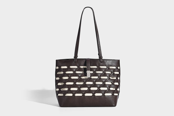 Structured woven lattice cutout tote bag with smooth leather-look trim, dual shoulder straps, and silver-tone hardware