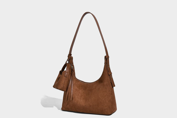 Dark brown suede-look hobo shoulder bag with top zip closure, adjustable strap, and small detachable mini pouch, detail view