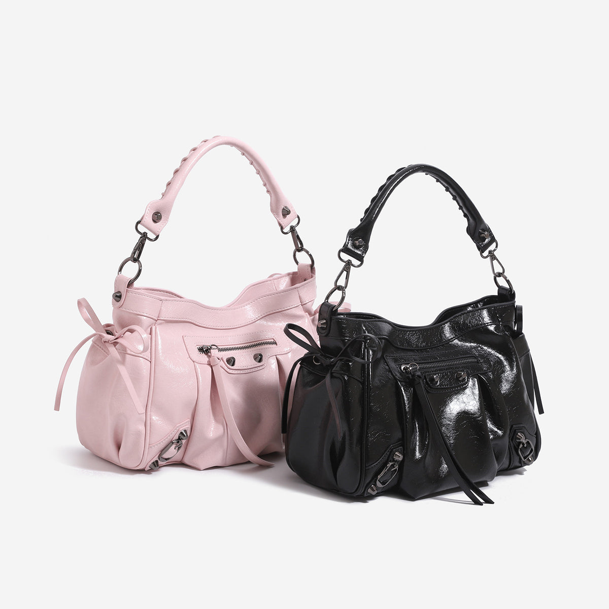 Slouchy glossy crinkle leather-look shoulder bag with silver stud accents, tassel ties, front zip pocket, and top handle