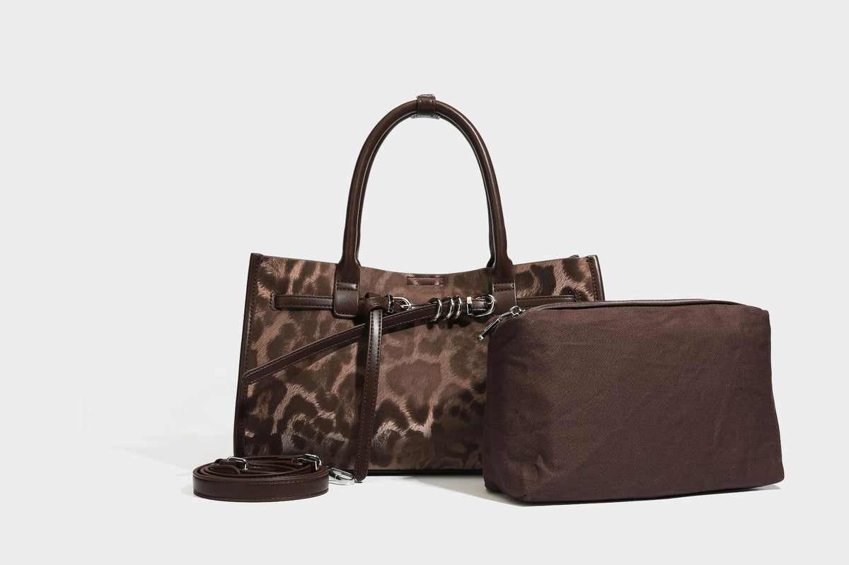 Structured leopard-print tote bag with glossy satin-like finish, dual rounded top handles, silver buckle-and-ring front