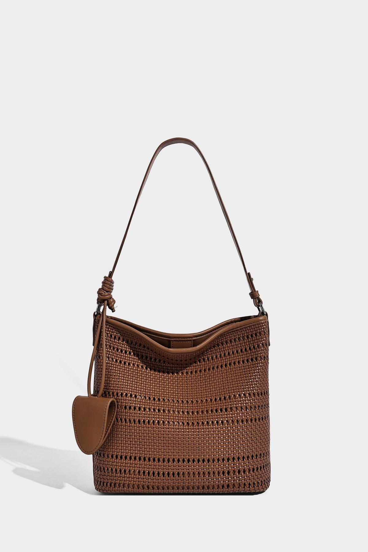 Handwoven open-weave shoulder bag with leather-look trim, knotted adjustable strap, and clip-on sunglasses sleeve pouch