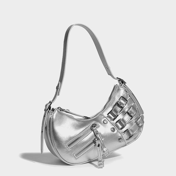 Crescent shoulder bag in washed blue denim-look PU with stacked buckle straps, front zip pocket, and silver-tone hardware