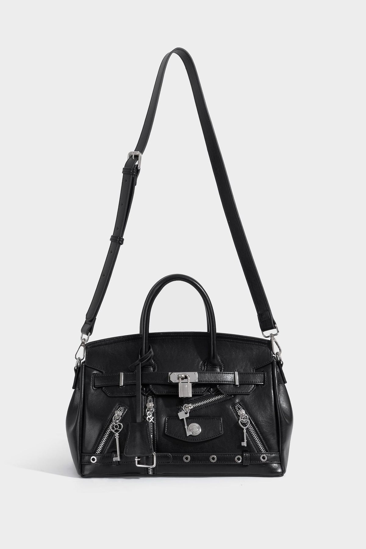 Structured black leather-look satchel bag with silver padlock hardware, front zip pockets, key charms, and top handles