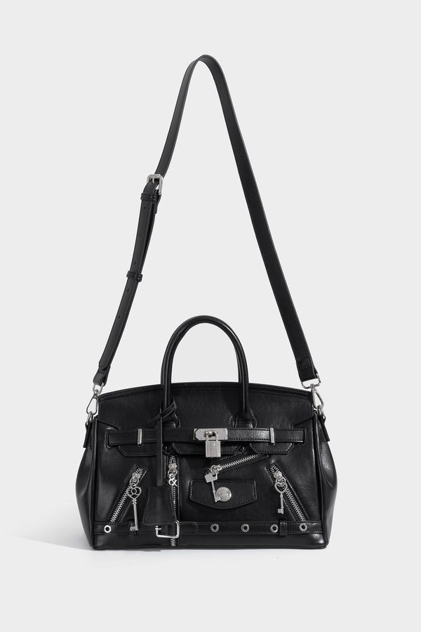 Structured black leather-look satchel bag with silver padlock hardware, front zip pockets, key charms, and top handles