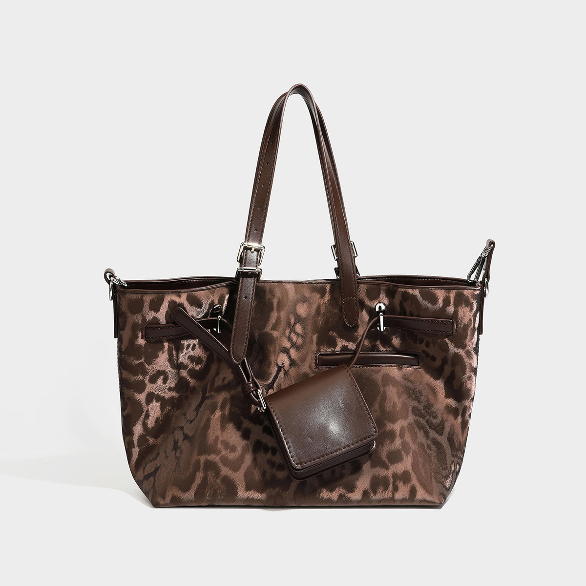 Glossy leopard-print tote bag with leather-look dark trim, dual top handles, detachable shoulder strap, and attached front