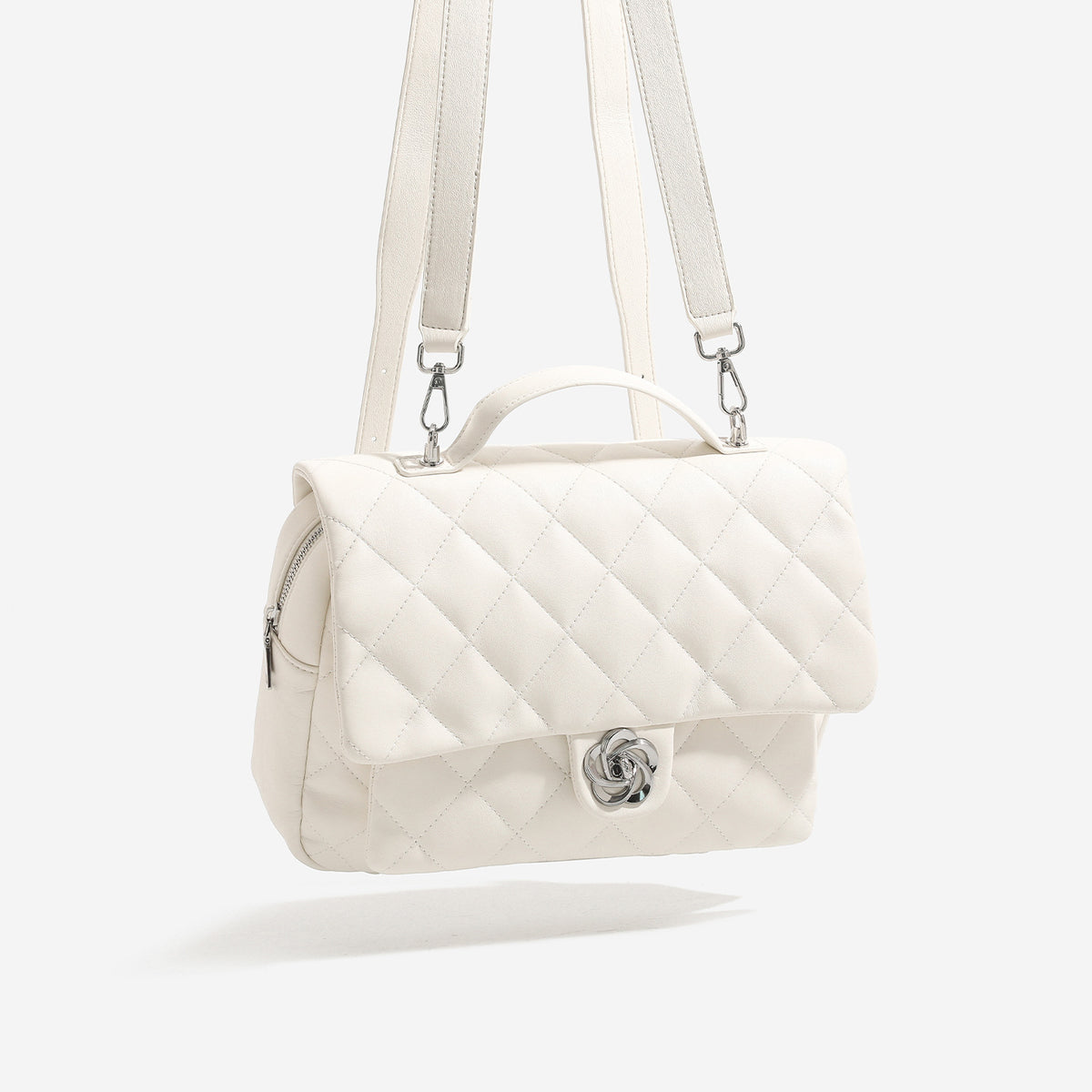 Diamond-quilted flap backpack handbag with silver-tone flower turn-lock, top handle, and dual shoulder straps, detail view 4