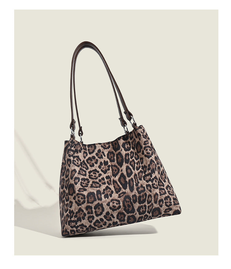 Leopard-print fabric tote bag with white plush teddy bear appliqué and brown leather-look shoulder straps, detail view 12