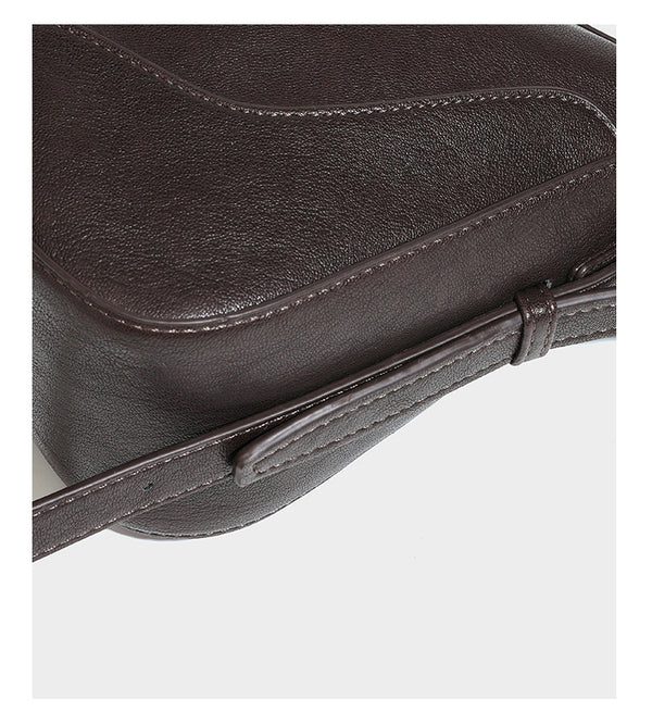 Slouchy crescent hobo shoulder bag in dark brown pebbled leather-look finish with zip top and long shoulder strap, detail