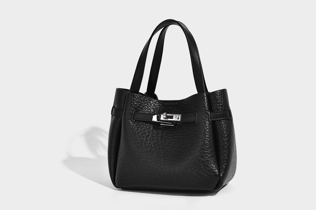 Small structured pebbled bucket tote with double top handles, silver turn-lock hardware, and detachable shoulder strap