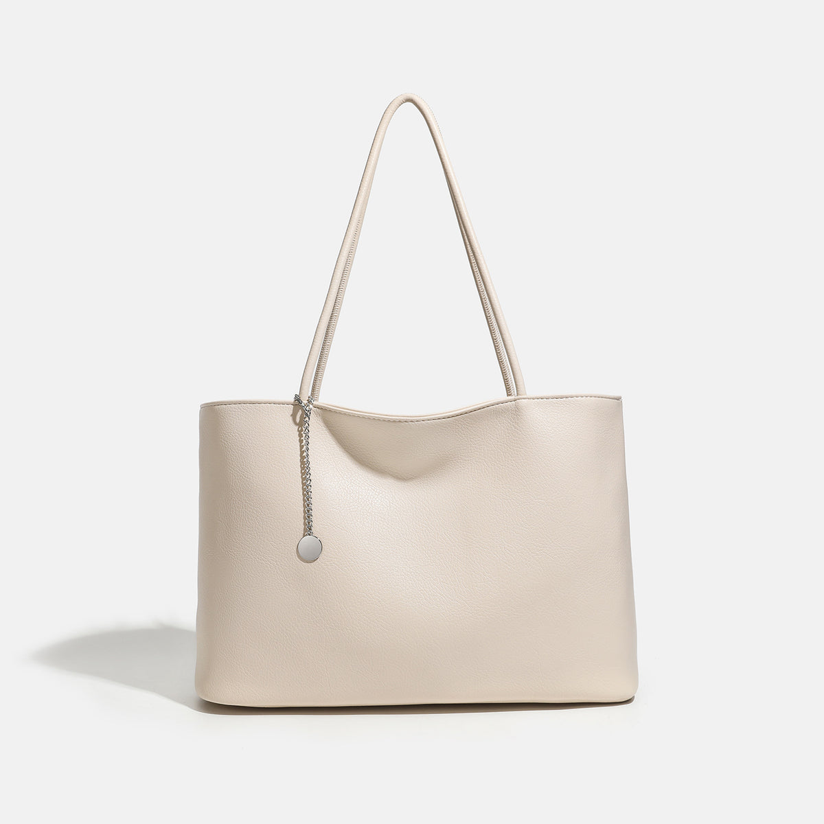 Large open-top tote bag with textured leather-look finish, long shoulder straps, and silver chain charm, front view