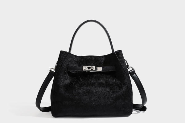 Small structured bucket satchel in embossed velvet-texture fabric with silver turn-lock hardware, rounded top handle, and