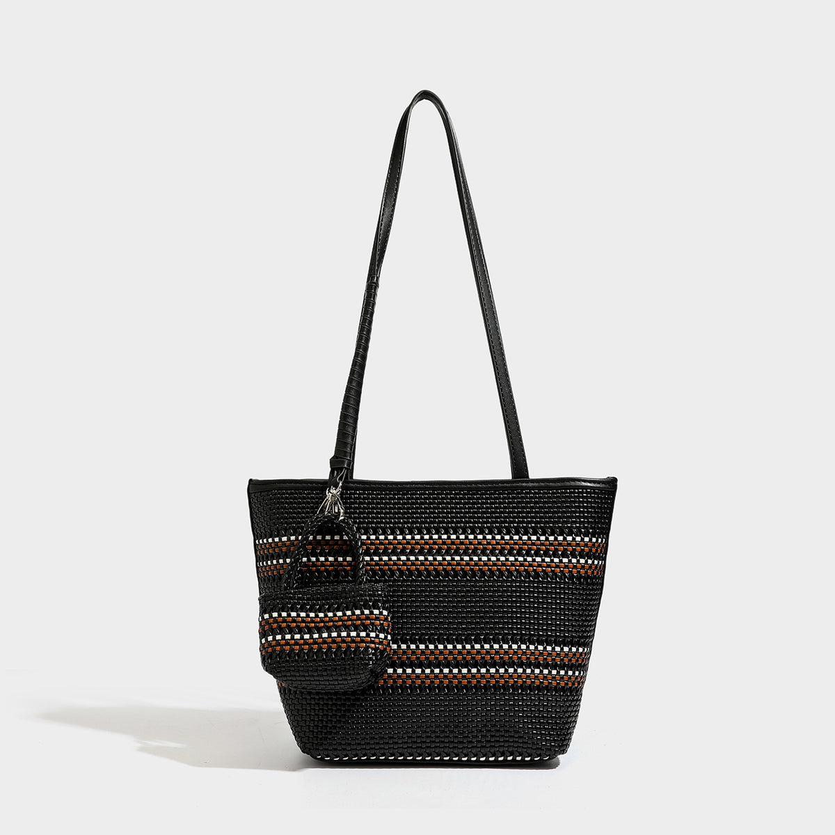 Large structured woven tote bag with striped basket-weave finish, long shoulder straps, and detachable mini pouch charm