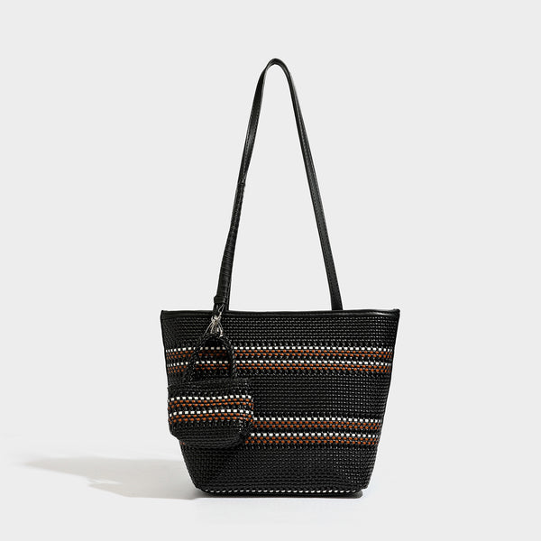 Large structured woven tote bag with striped basket-weave finish, long shoulder straps, and detachable mini pouch charm