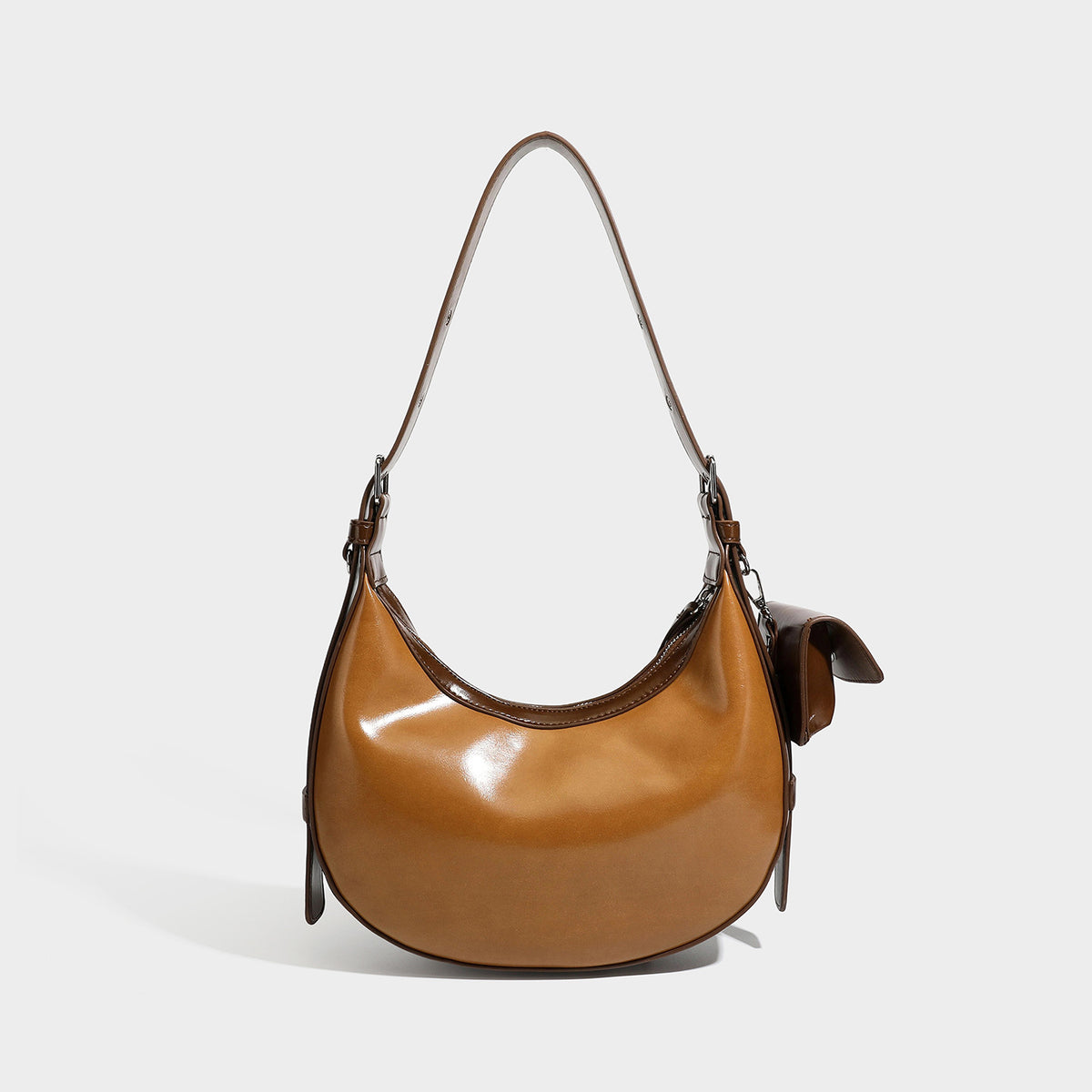 Glossy leather-look crescent hobo shoulder bag with dark contrast trim, silver-tone hardware, and attached mini flap pouch
