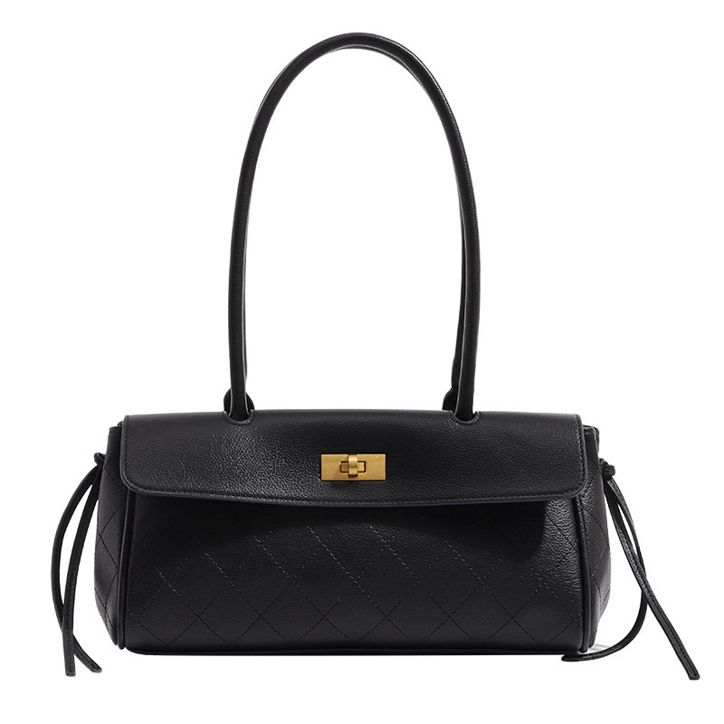 Structured quilted diamond top-handle underarm shoulder bag with gold-tone turn-lock flap closure and side tie straps, detail
