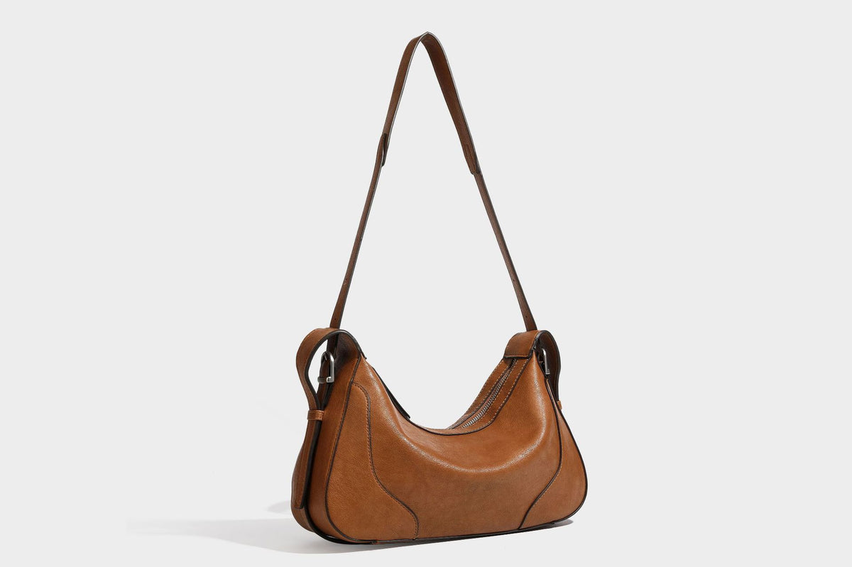 Slouchy crescent hobo shoulder bag in dark brown pebbled leather-look finish with zip top and long shoulder strap, detail