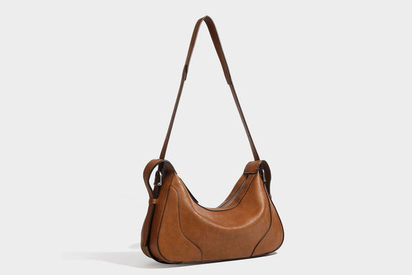 Slouchy crescent hobo shoulder bag in dark brown pebbled leather-look finish with zip top and long shoulder strap, detail