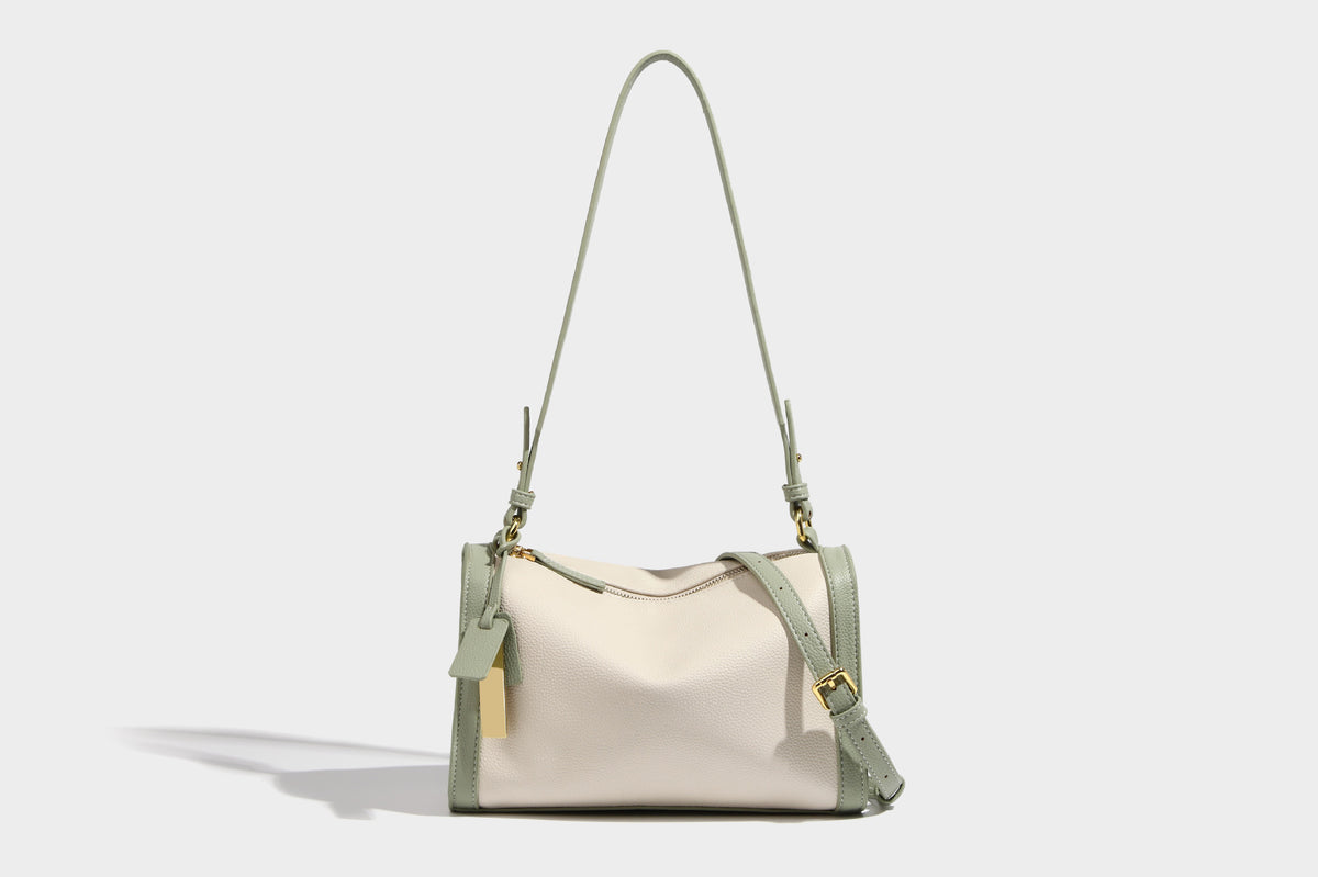 Structured two-tone shoulder bag with pebbled leather-look finish, contrast trim, top zip closure, and gold-tone hardware