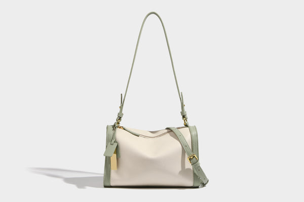 Structured two-tone shoulder bag with pebbled leather-look finish, contrast trim, top zip closure, and gold-tone hardware