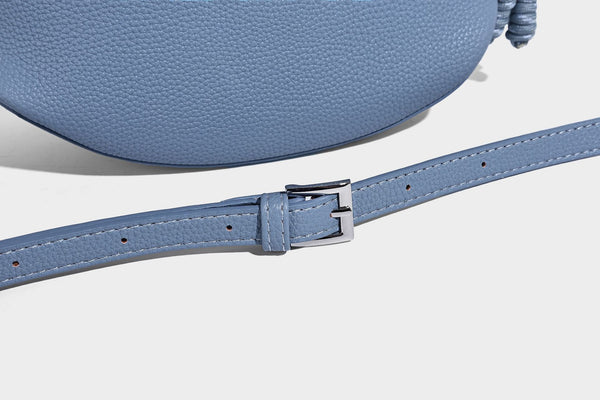 Small crescent half-moon bag in pebbled leather-look finish with braided top handle, silver-tone ring hardware, and, detail