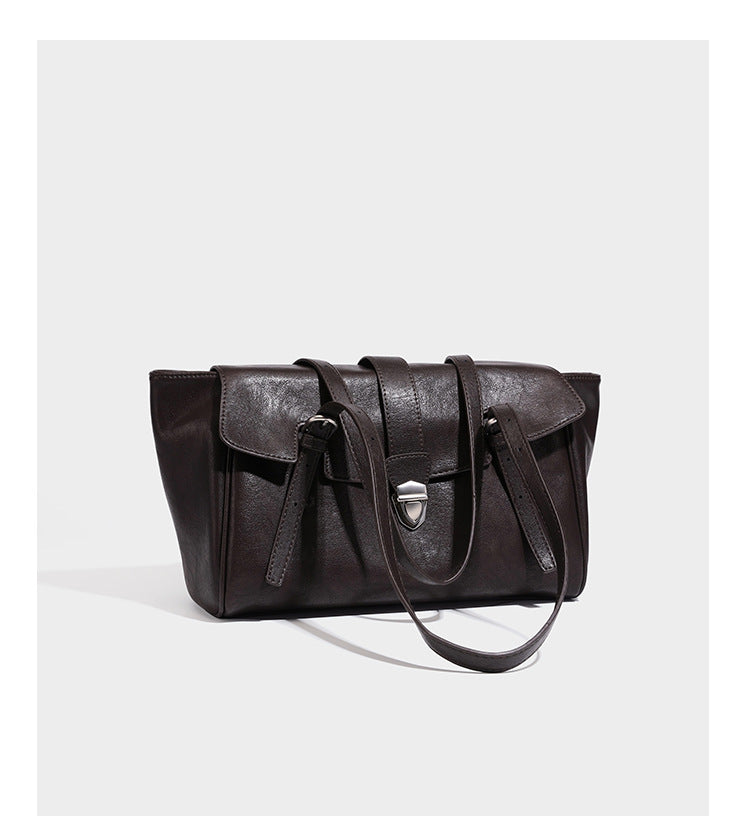 Large structured vintage-style tote bag with flap-front turn-lock closure, twin buckle straps, and double shoulder handles