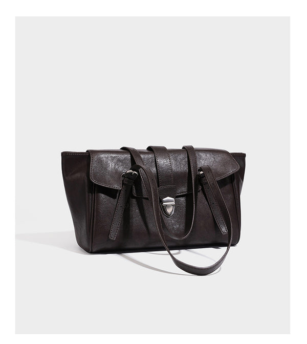 Large structured vintage-style tote bag with flap-front turn-lock closure, twin buckle straps, and double shoulder handles