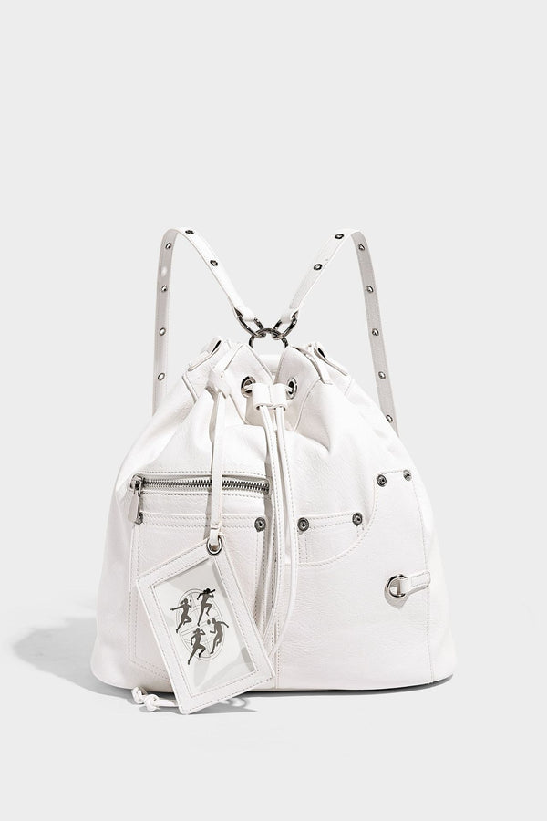 Glossy black convertible bucket backpack with silver grommet-studded straps, drawstring cinch closure, and front zip pocket