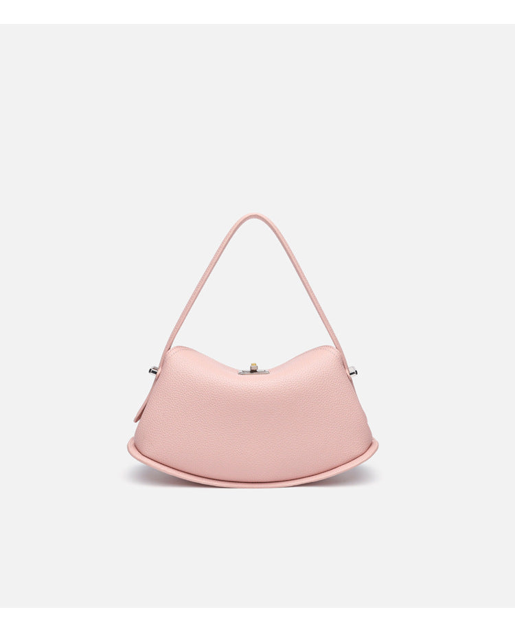 Pebbled leather-look half-moon saddle bag with turn-lock flap closure, top handle, and detachable crossbody strap, detail
