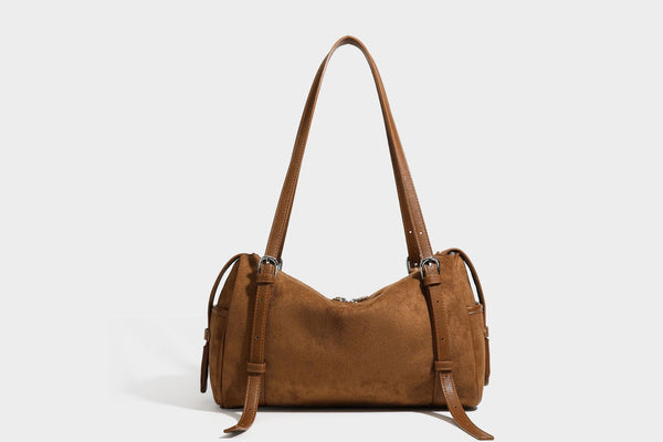 Large brown suede-finish barrel shoulder bag with dark leather-look trim, silver-tone zippers, dual top handles, and long