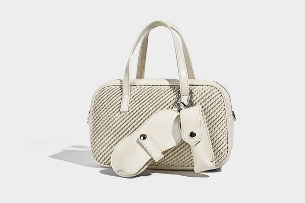 Structured woven-texture front top-handle handbag with zip closure, dual handles, detachable shoulder strap, and matching