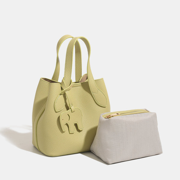 Pebbled leather-look bucket tote with elephant charm pendant, dual top handles, and detachable shoulder strap, detail view 3