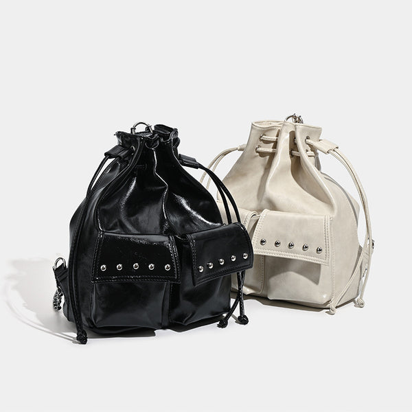 Glossy leather-look drawstring bucket bag with silver dome studs and chain shoulder strap, detail view 2