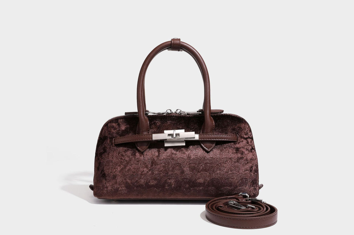 Small structured satchel bag in dark brown velvet-like textured finish with leather-look trim, silver-tone turn-lock bar