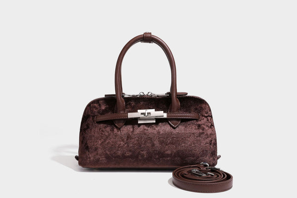Small structured satchel bag in dark brown velvet-like textured finish with leather-look trim, silver-tone turn-lock bar