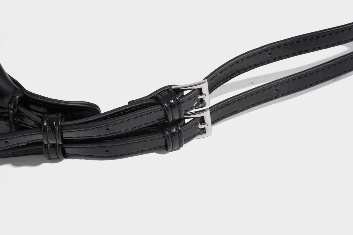 Glossy black slouchy hobo shoulder bag with zip closure, silver-tone ring hardware, and adjustable crossbody strap, detail