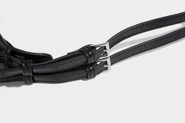 Glossy black slouchy hobo shoulder bag with zip closure, silver-tone ring hardware, and adjustable crossbody strap, detail