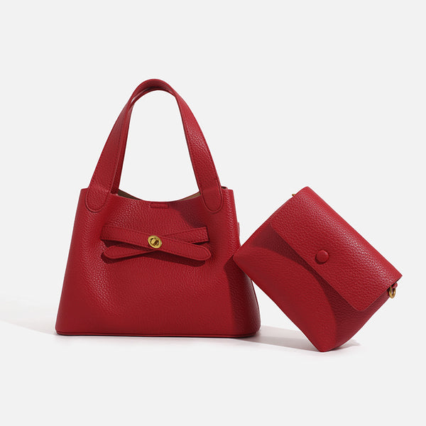Pebbled trapezoid tote bag with gold turn-lock strap detail and matching snap pouch, front view
