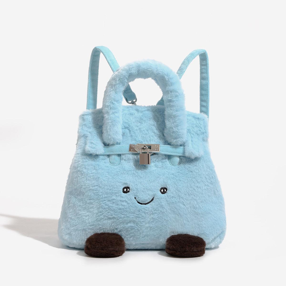 Ice-blue plush faux-fur Kelly-style convertible bag with embroidered smiling face, dark pom-pom feet, silver-tone clasp