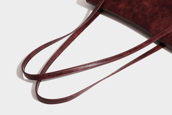 Structured flap-top shoulder tote bag in distressed leather-look finish with silver-tone buckle hardware and double shoulder