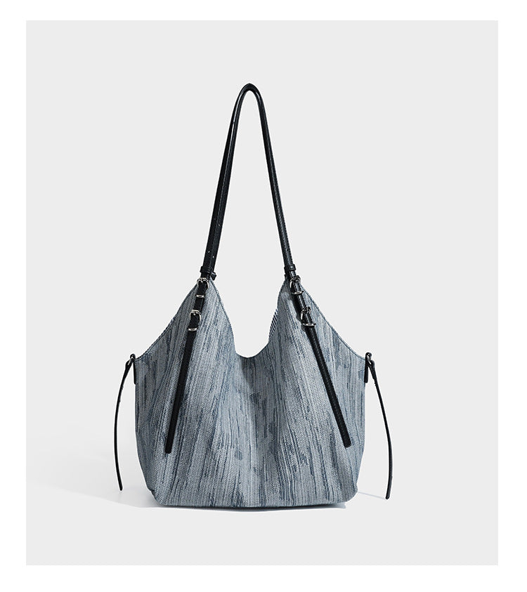 Large slouchy woven-texture shoulder tote bag with slim leather-look straps, side cinch ties, and silver-tone hardware